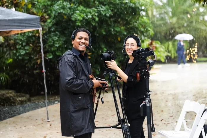 Justo and Maria Peña shooting a ceremony in the rain