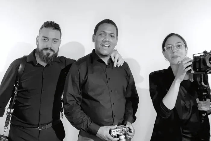 Three operators posing together in black