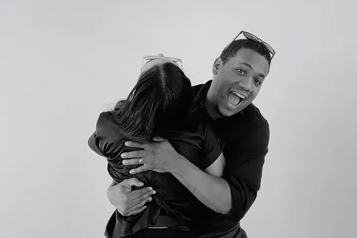 Justo Peña hugging a teammate in the booth