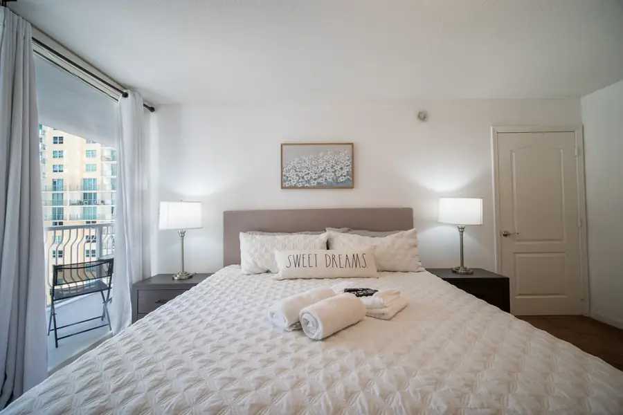 Bedroom with skyline view and turned-down bedding