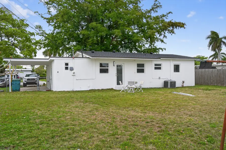 Fenced backyard with mature shade trees